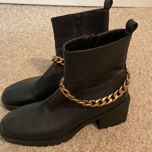 Black leather boots with gold chain